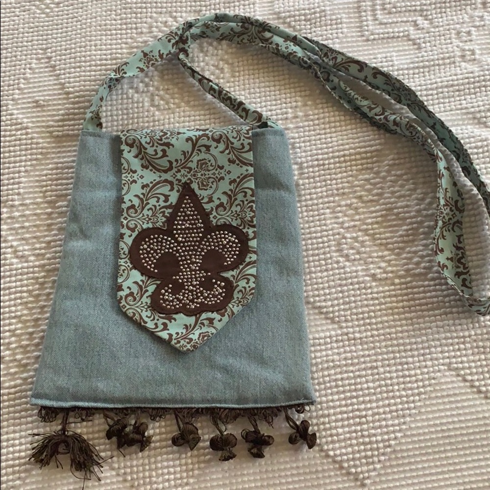 Denim purse with Fleur de lis design on front flap
